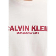 White Calvin Klein men t-shirt with bold red Calvin Klein and established 1968 lettering across the chest