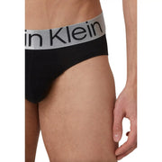 Black Calvin Klein men’s briefs with a gray waistband featuring the brand’s logo in black lettering