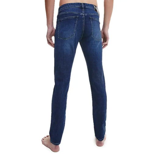 Calvin Klein men’s blue denim jeans with classic straight-leg cut and visible stitching details