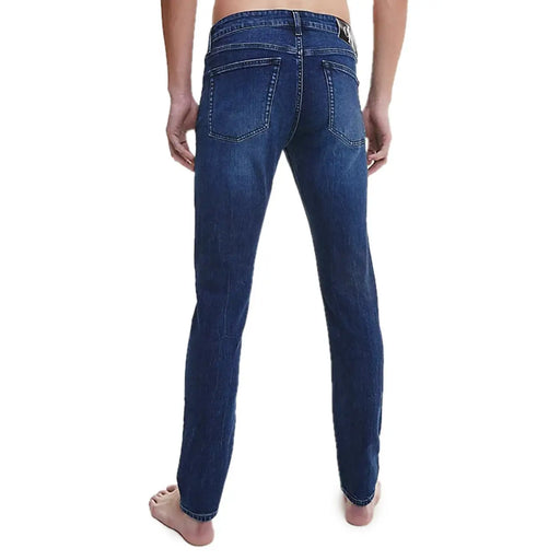 Calvin Klein men’s blue denim jeans with classic straight-leg cut and visible stitching details