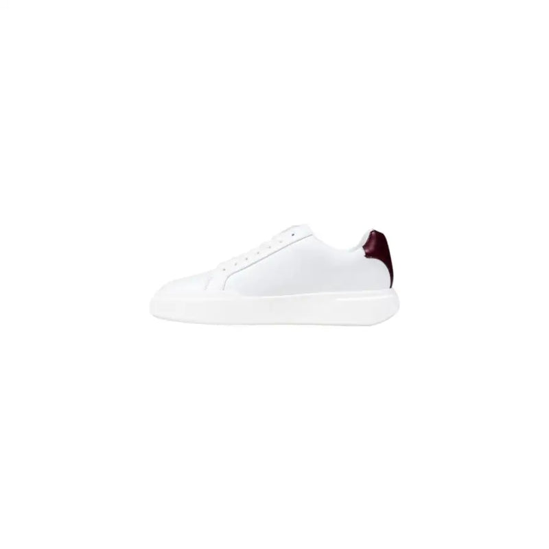 White leather sneaker with burgundy accent and logo on heel.