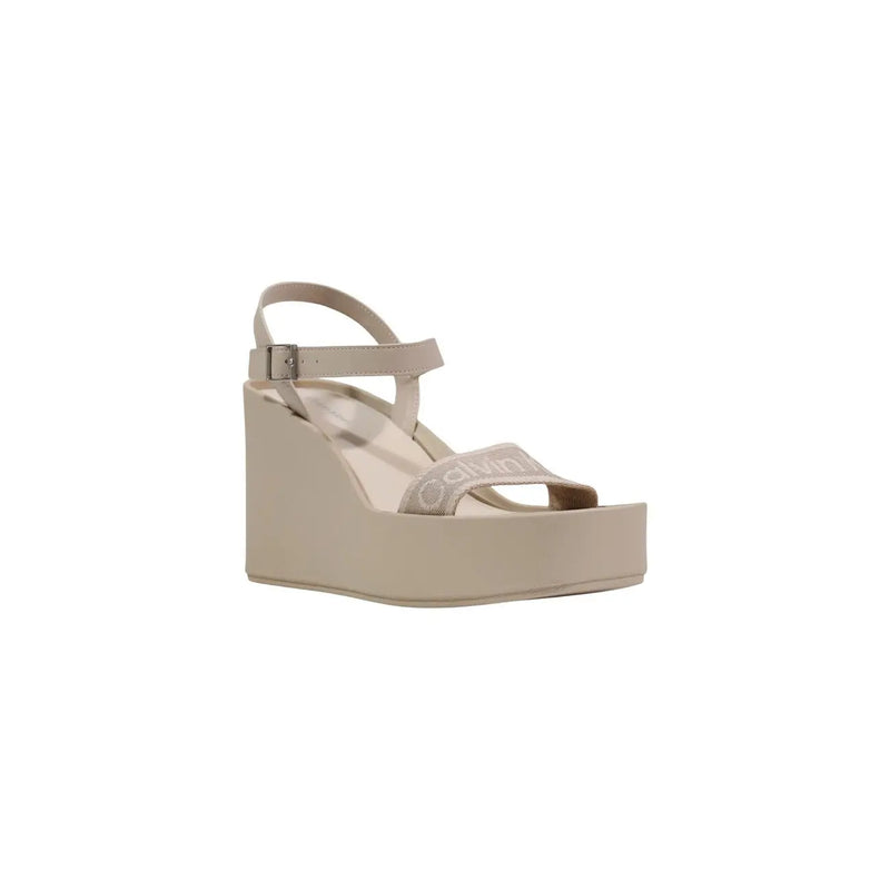 Calvin Klein women beige platform wedge sandal with thin ankle strap and decorative band across the foot