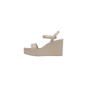 Beige platform wedge sandal by Calvin Klein with sleek minimalist smooth leather straps and buckle detail