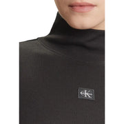 Calvin Klein Damen-Strickwaren, schwarzer gerippter Rollkragenpullover aus Baumwolle top mit Logoaufnäher auf der Brust