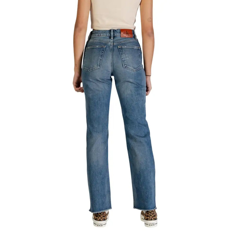 High-rise straight-leg medium-wash blue denim jeans with classic back pockets and brown leather Calvin Klein patch