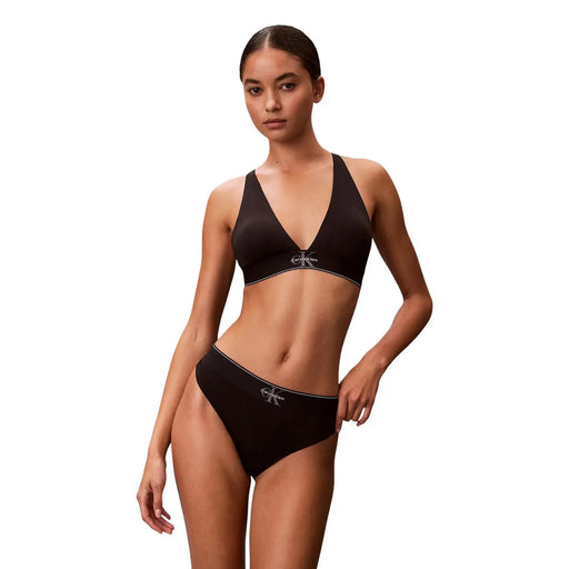 Black calvin klein bikini set with minimalist design and white logo detailing made of white polyester thong material