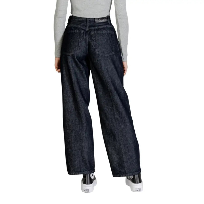Dark indigo cotton wide-leg jeans with high waist and classic back pockets shown from the back by Calvin Klein