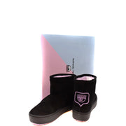 Black suede ankle boots with pink embroidered eye logo by chiara ferragni displayed in front of branded box