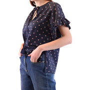 Navy blue women’s short-sleeve blouse with pink polka dots, v-neck tassel ties, ruffled sleeves