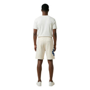 Baumwollshorts von County Of Milan für Herren in Creme mit auffälligem blauem geometrischem Aufnäher am linken Bein, Vorderansicht
