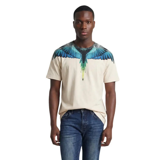 Beige cotton short-sleeved men t shirt from County of Milan with vibrant blue and green wing graphic on shoulders