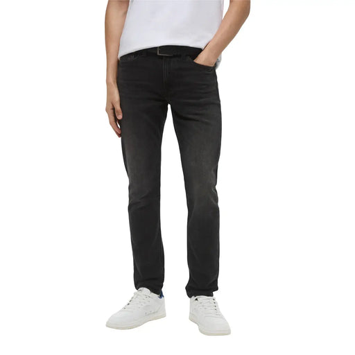 Man wearing navy hooded jacket and dark wash jeans showcasing men’s fashion attire