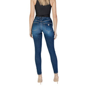 Dark wash skinny denim jeans in dark blue with a subtle fade and guess logo on the back pocket shown from behind
