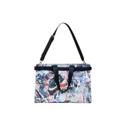Black cotton tote bag with colorful abstract print, top handles, shoulder strap, and interior pockets