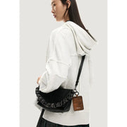 Desigual black polyurethane crossbody handbag with textured finish braided strap and leather tag for shoulder use