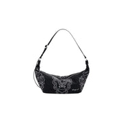 Black polyurethane shoulder bag with white studded embellishments, zip closure, and inner pocket