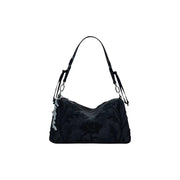 Black polyurethane tote bag with floral embossing and silver hardware for women