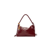 A glossy burgundy polyester desigual bordeaux handbag with braided handle and tan accents featuring a zip pocket
