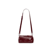 A sleek glossy burgundy leather Desigual bordeaux women crossbody bag with button closure and inside pocket