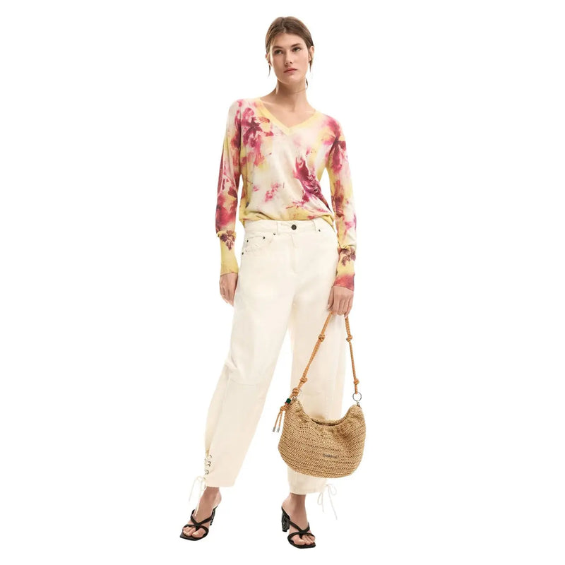A woven straw handbag with a curved crescent shape and natural tan color featured with desigual pink floral knitwear for women
