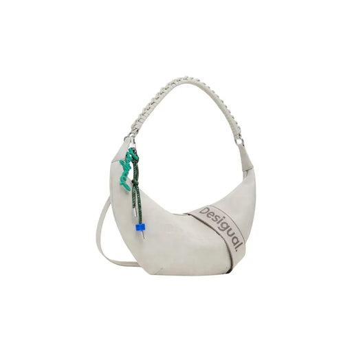 Off-white crescent-shaped shoulder bag with decorative charm and textured strap for women