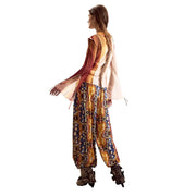 A woman wears a desigual women beige long sleeve round neck classic shirt with sheer layered sleeves and patterned wide-legged pants