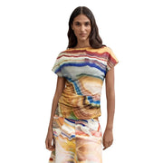 A woman wearing a Desigual women beige round neck polyester t shirt with vibrant multicolored abstract stone pattern