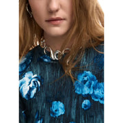 Silver sculpted choker necklace with flowing interlocking ring design paired with desigual black floral knitwear