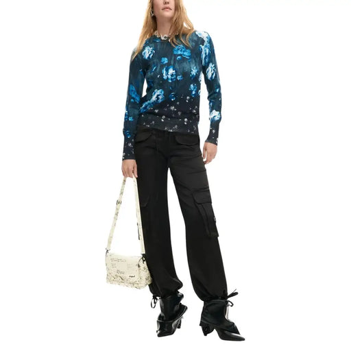 Desigual women black floral knitwear paired with a cream crossbody bag featuring newspaper print and black hardware