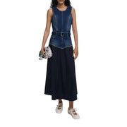 Women wearing a two-tone denim and black maxi dress with belt and multicolored clutch