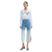 Light blue denim jeans with gradient fade to white and colorful floral embroidery on side seams by desigual