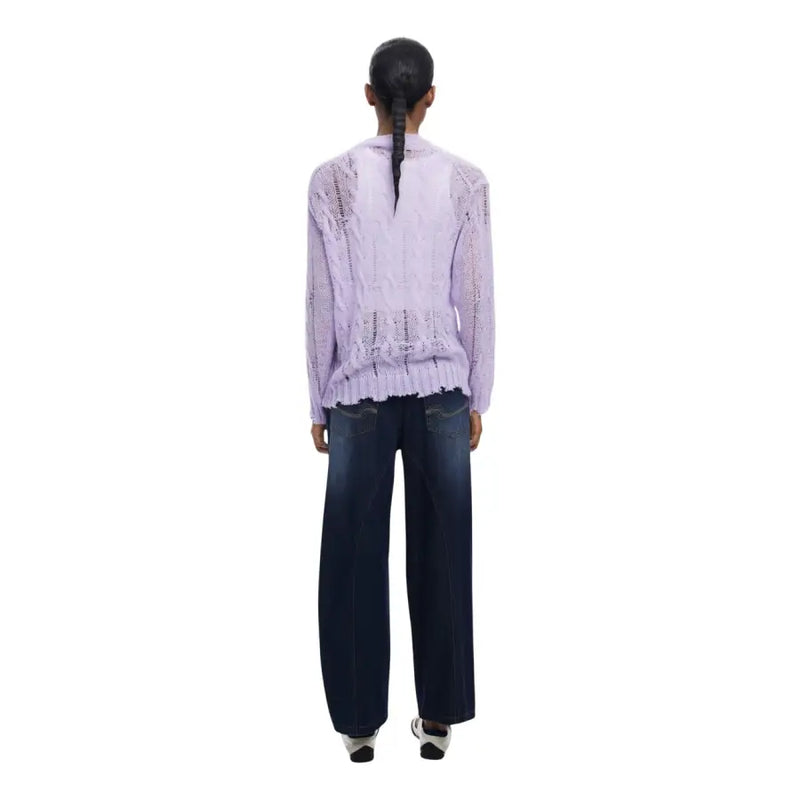 Woman from behind wearing light purple long-sleeved top and dark blue wide-leg jeans