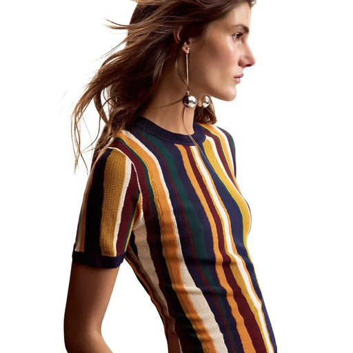 A woman wears a short-sleeved knitted dress with mustard yellow striped viscose fabric by Desigual