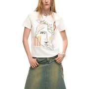 White cotton round neck short t shirt by Desigual with short sleeves and stylized face graphic in orange yellow and gray accents