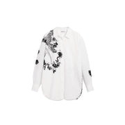 Desigual women white long cotton shirt with classic collar featuring bold black floral and leaf pattern on left side
