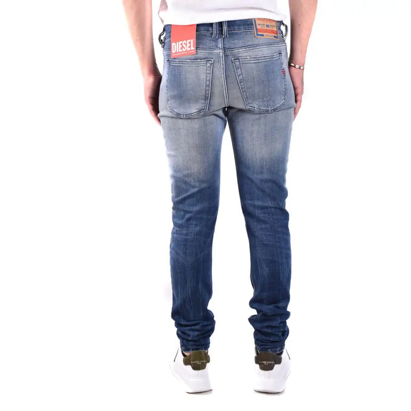 Back view of diesel men blue cotton jeans with faded wash and distressed details on the waistband label