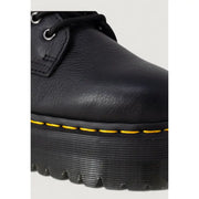 Dr Martens black leather ankle boot with platform sole and distinctive yellow stitching along the sole