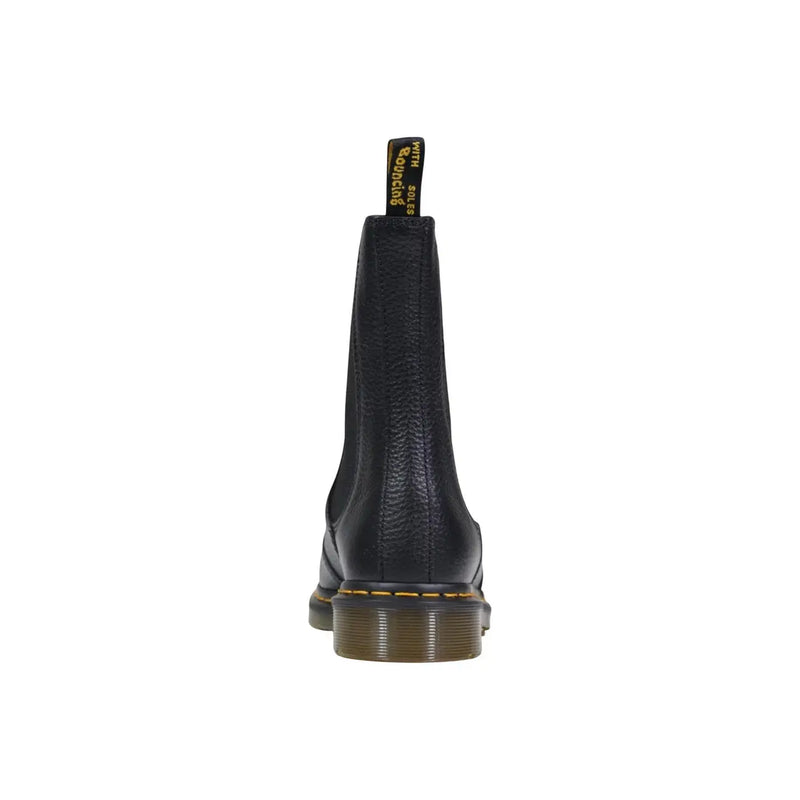 Dr Martens black leather ankle boots for women with textured finish and yellow stitching along the sole