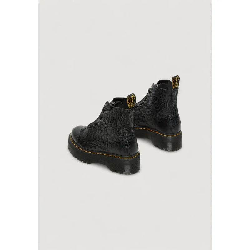 Dr martens black leather ankle boots for women shown from the back side highlighting the leather texture