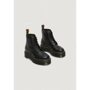 Dr Martens black leather ankle boots for women showing the back side with signature heel loop detail