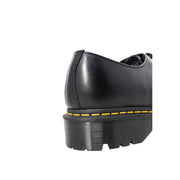 Dr martens men’s black leather lace-up shoes showing the back side with key stitching and heel loop details
