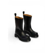 Dr Martens women black leather ankle boots with chunky rubber sole and pull tabs shown from the back side