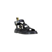 Black leather buckle sandals for women by dr martens shown from the back side highlighting the leather material