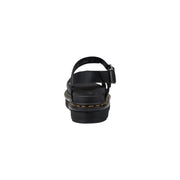 Dr Martens women black leather platform sandals with thick sole, adjustable buckle strap, and signature yellow stitching