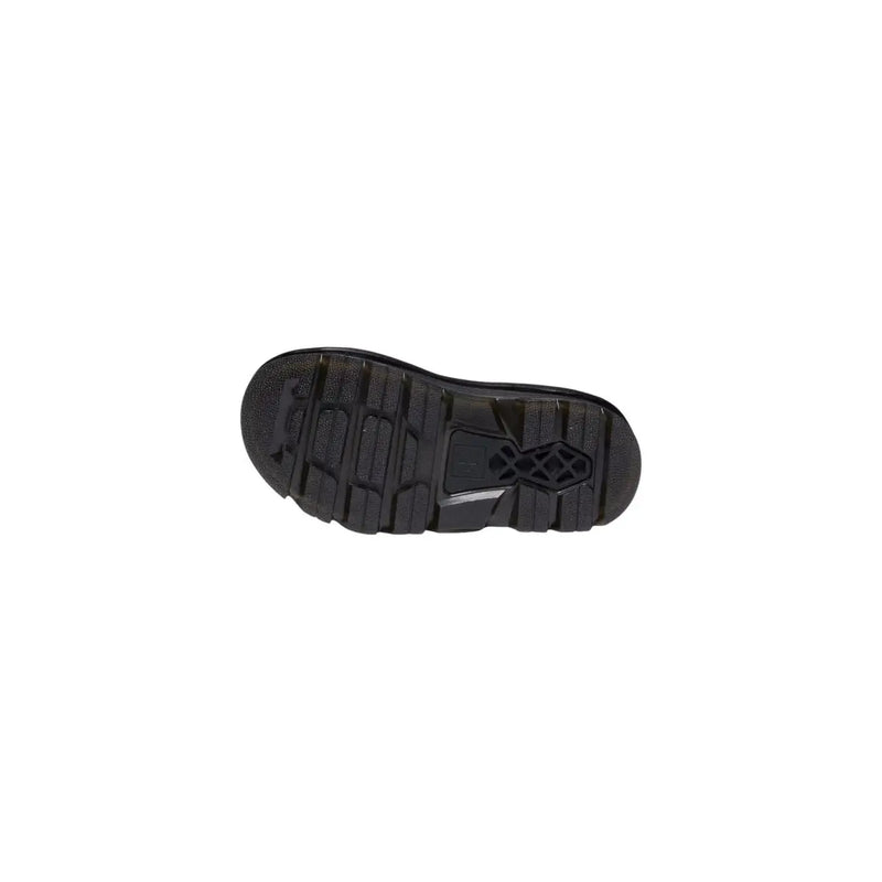 Black rubber sole with textured tread and central logo on dr martens women tan leather buckle sandals