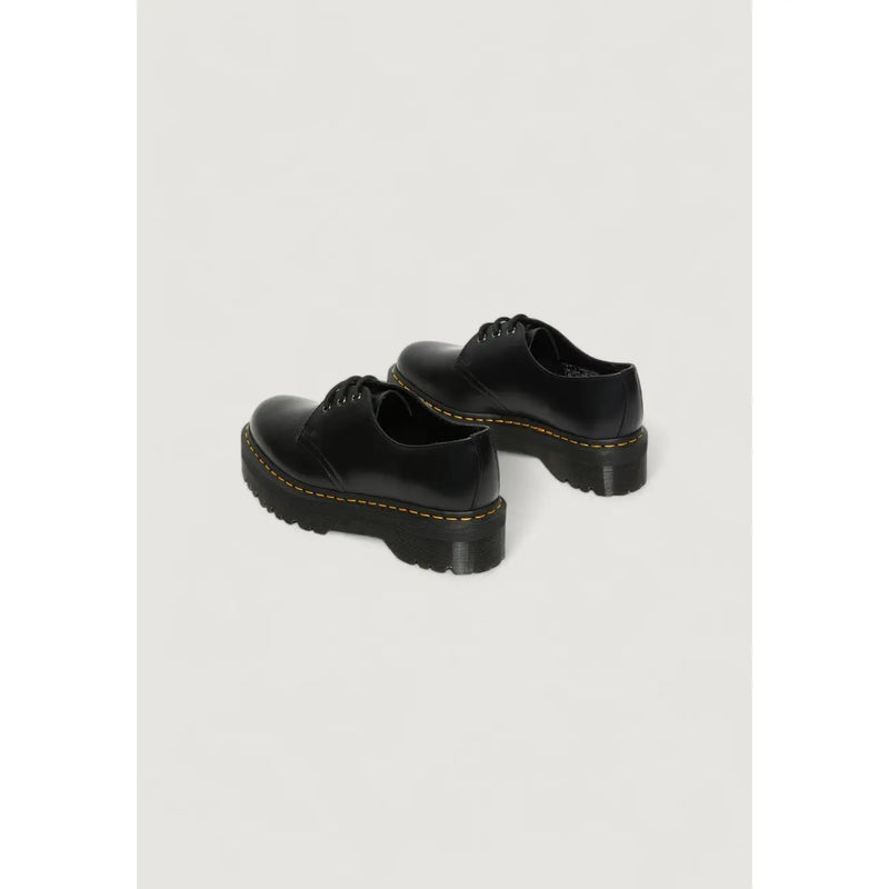 Dr Martens women’s black leather lace up shoes shown from the back side highlighting their durable design