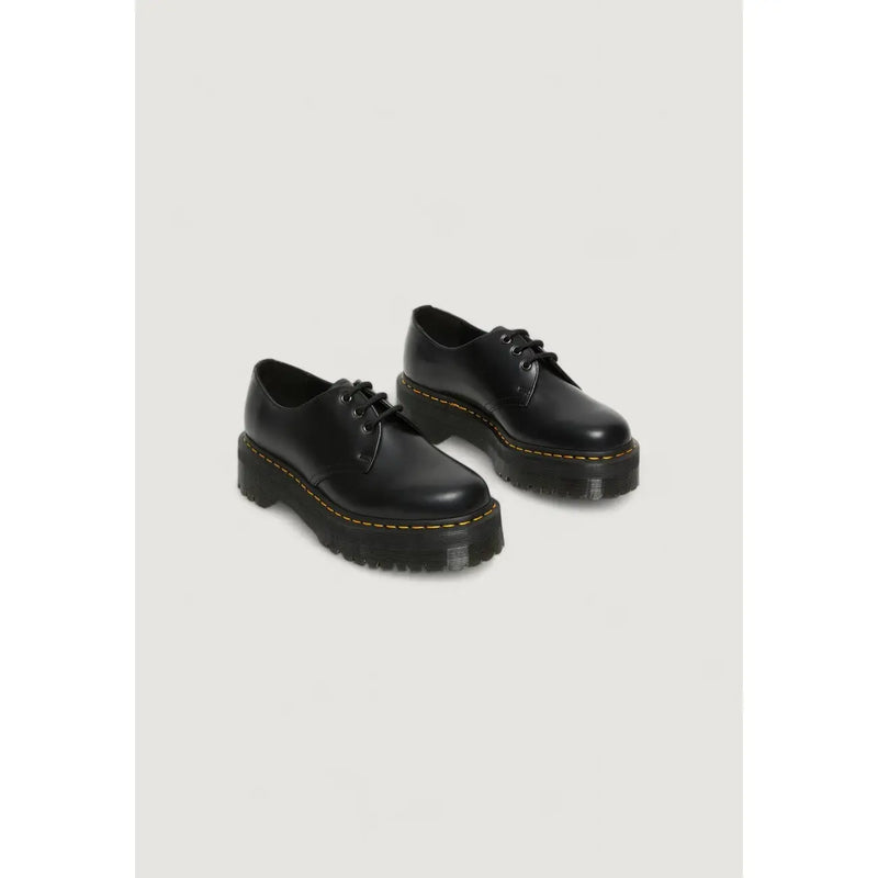 Black leather lace up dr martens women’s shoes shown from the back side with signature outsole and stitching