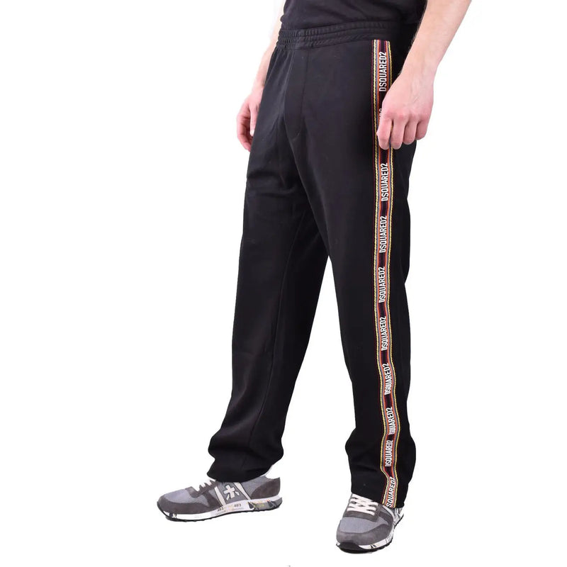 Dsquared men black cotton blend track pants with bold vertical stripe featuring white and gold brand logo lettering