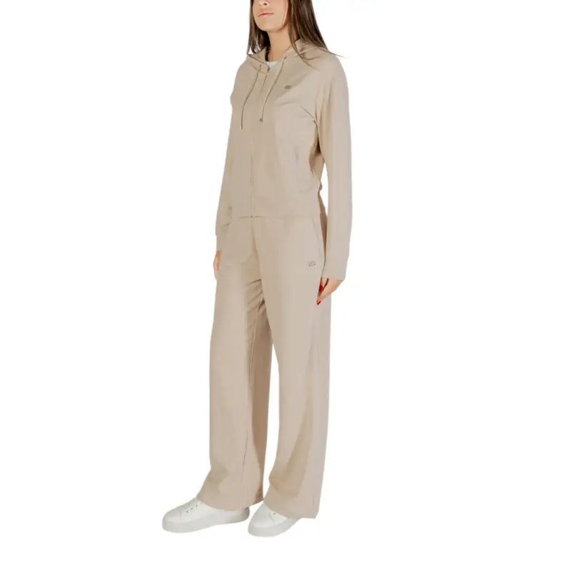 Woman wearing Ea7 beige hooded cotton elastane jumpsuit with front pockets and zip