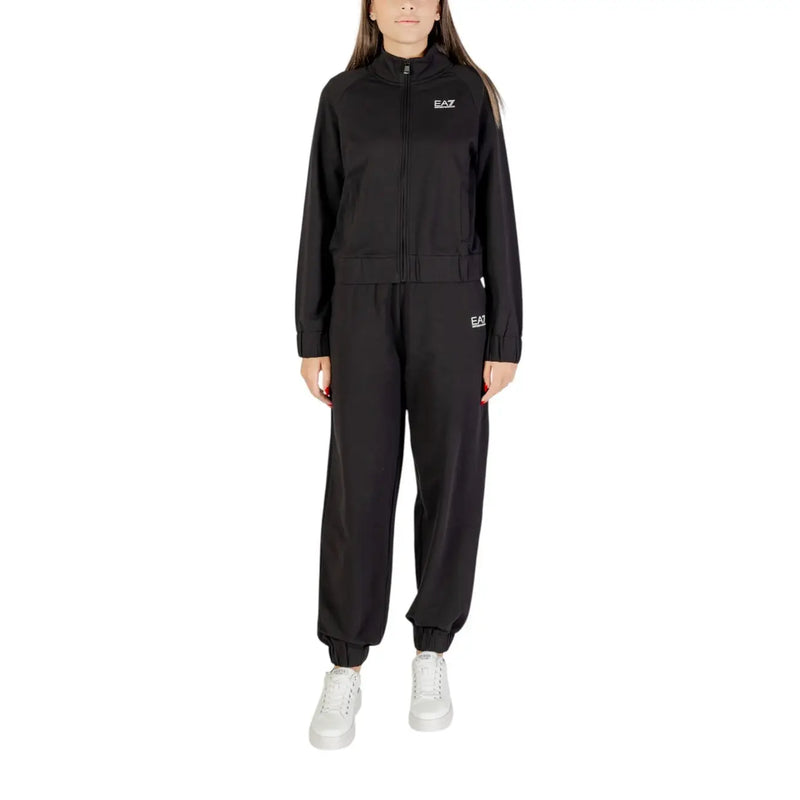Women wearing a black full-zip tracksuit and white sneakers for activewear